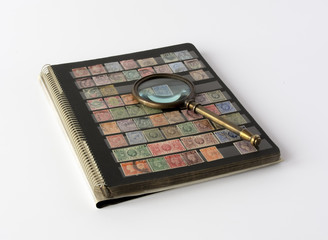 Stamps album with magnifying glass