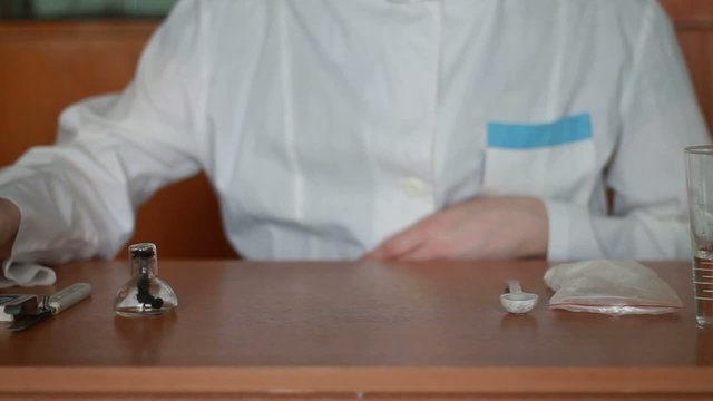 Girl shemist dissolving the powder in water and mixing