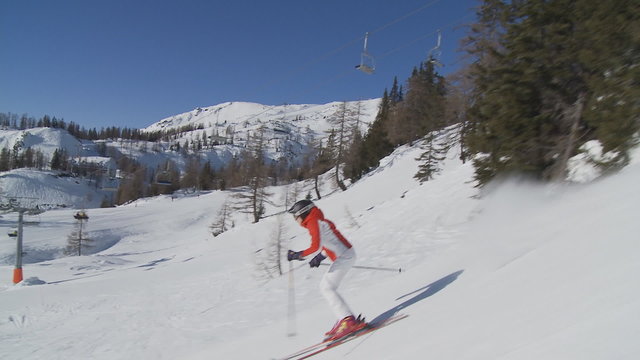 woman skiing on sunny day accompanied by camera part II of II
