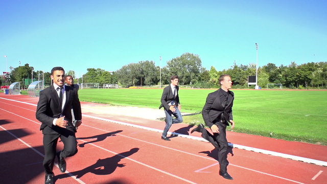 slow motion business men finishing run