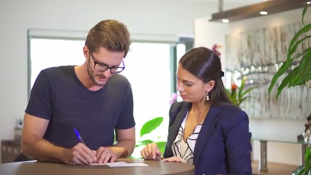 woman helping man with form
