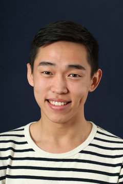 Smiling young Asian man looking at camera