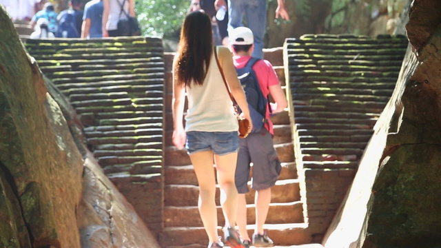 SIGIRIYA, SRI LANKA - FEBRUARY 2014: People passing by in Sigiriya, an ancient palace located in the central Matale District near the town of Dambulla in the Central Province.
