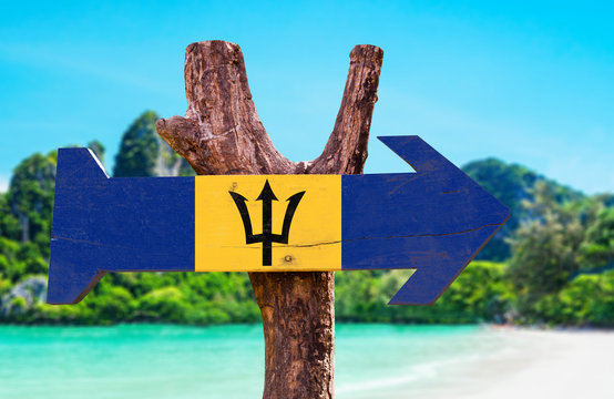 Barbados Flag wooden sign with beach background
