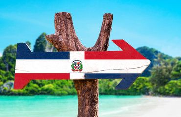 Dominican Republic Flag wooden sign with beach background