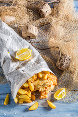 Tasty fish and chips with lemon