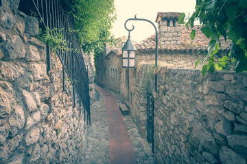 Narrow street paved with stone slabs in Eze village, France