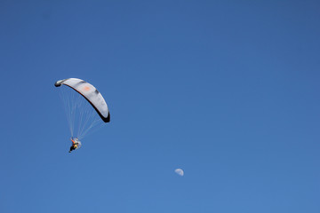 flying paraglider near the moon