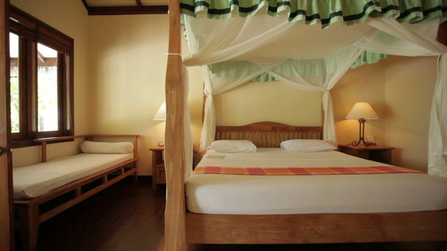 dolly shot of four-poster bed