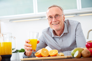 Senior man with a glass of orange juice