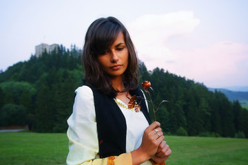 girl in historical costume in a holding romantic rose