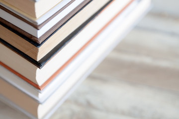 stack of books on wooden desk