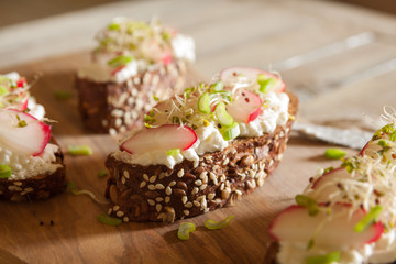 Snack sandwiches with cottage cheese on a brown seedy bread