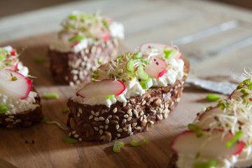 Mini sandwiches with cottage cheese on a brown seedy bread