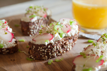Mini sandwiches with cottage cheese on a brown seedy bread