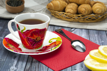 cup of tea with poppies, croissants , breakfast