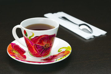 cup of tea with poppies and spoon