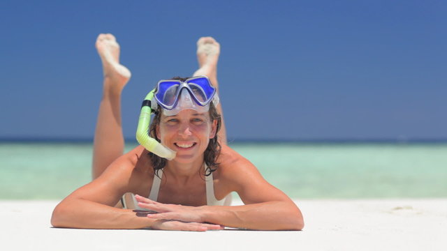 woman with snorkeling gear in front of camera