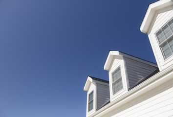 Roof of House and Windows Against Deep Blue Sky