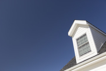 Roof of House and Windows Against Deep Blue Sky