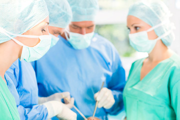 Surgeons operating patient in operation theater