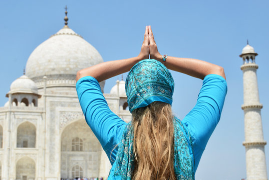Young woman meditating atTaj Mahal. Agra, India