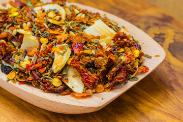 Colored spices for pasta mix on wooden spoon