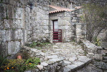 Fototapeta na wymiar rustic house made of stones and a wall