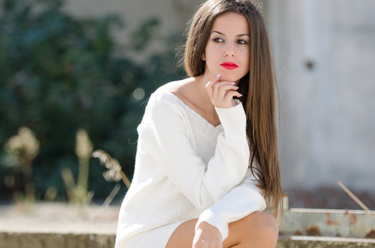 Lady sitting outside with passive look