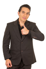 handsome young man wearing a suit posing with thumb up