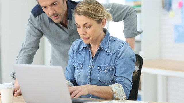 People working in office on laptop computer