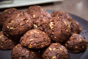 Chocolate and nut cookies on wooden table
