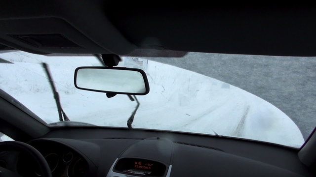 view from front seat of car on snow covered road