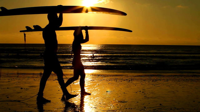Surfers at sunset