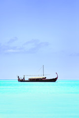Obraz premium View of beautiful blue ocean water with boat in Baros Maldives