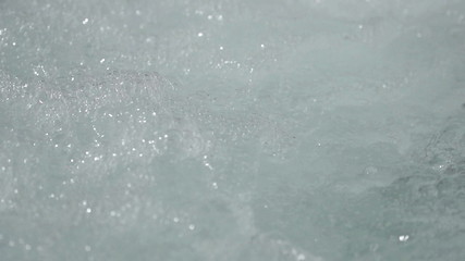 closeup bubbling warm water slow motion