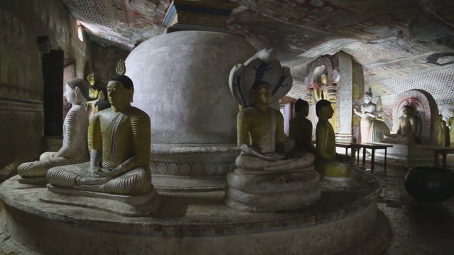 DAMBULLA, SRI LANKA - FEBRUARY 2014: Many sitting and standing Buddhas at the Golden Temple of Dambulla. The Golden Temple of Dambulla is a World Heritage Site in Sri Lanka.