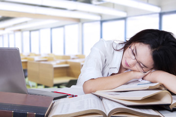 Exhausted teenage girl sleeping in class