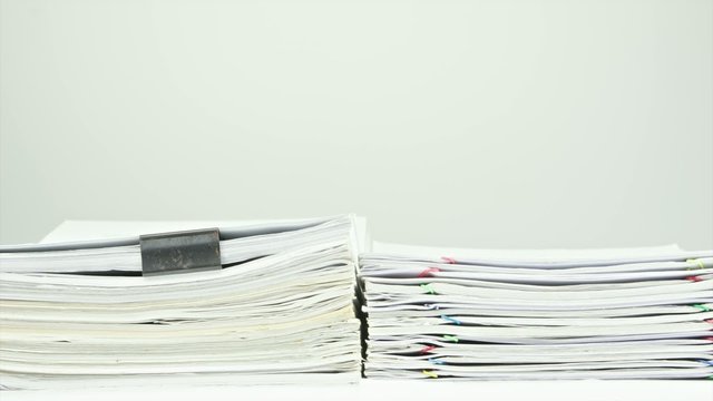 Stack old overload paperwork report on table time lapse