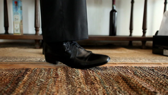 Man tying his black shoelaces