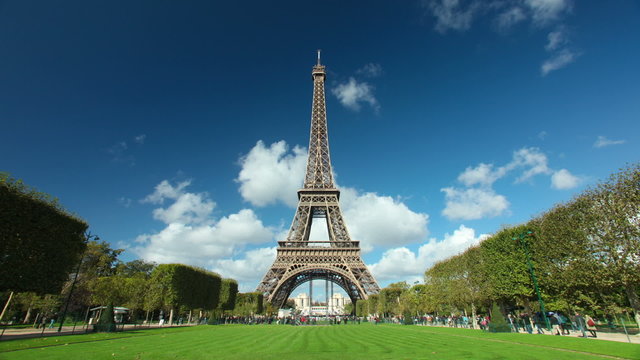 Timelapse of the eiffel tower with white clouds passing overhead in Paris, France