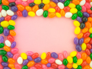 Fototapeta na wymiar Jelly Beans Frame and Background ( Pink Background )