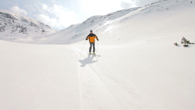 good skier following camera skiing off piste
