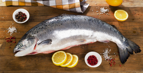 Atlantic Salmon  with lemon on  wooden board.