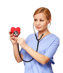 Nurse with stethoscope examining red heart, isolated on white