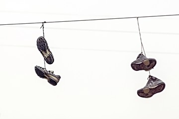 two couples fragmentary sneakers on wires