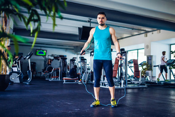 Fototapeta na wymiar Crossfit instructor at the gym doing Exercise, jumping rope