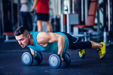 Crossfit instructor at the gym doing pushups