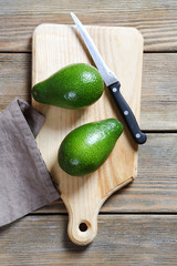 Two avocados on a cutting board