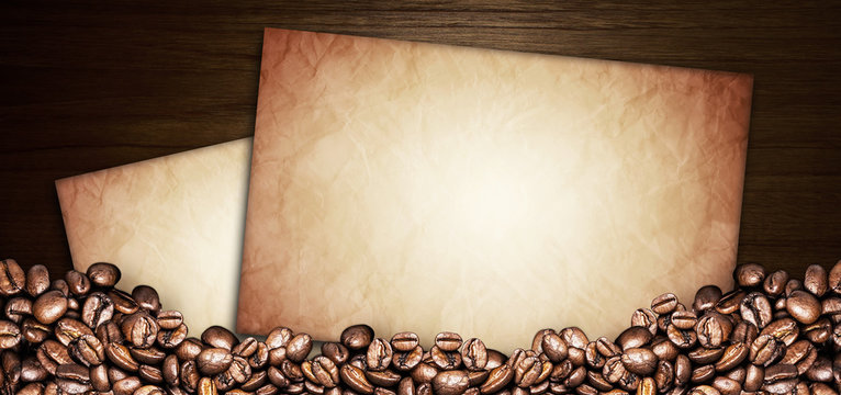 coffee beans and paper old on a wooden table. Dark background